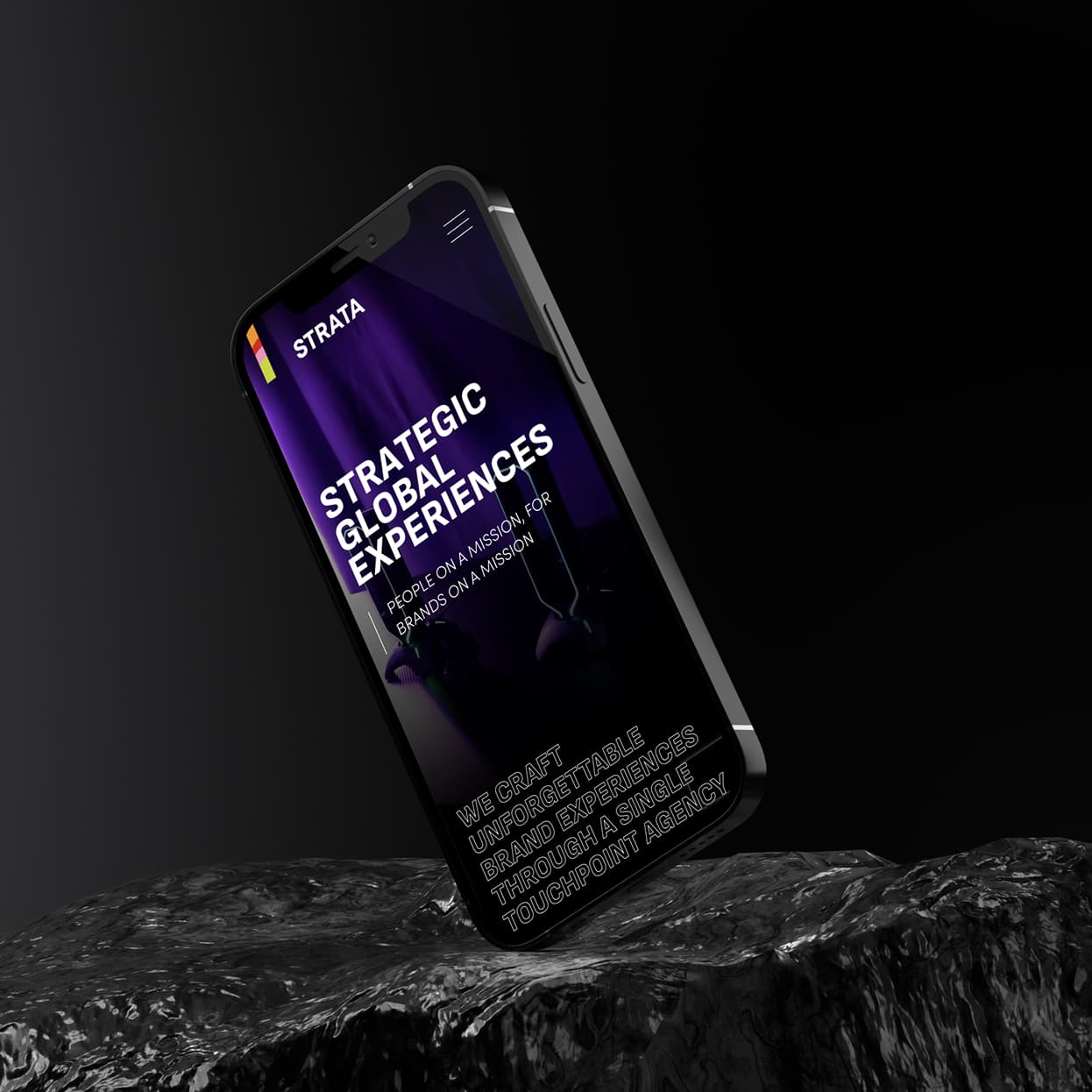 Strata mobile homepage on a phone standing on rock